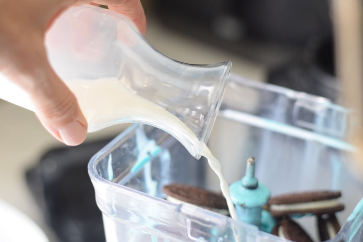 adding milk to blender